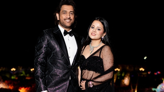 Cricketer MS Dhoni with his wife Sakshi Dhoni. On Wednesday, the Ambani family organized a community food service for 51,000 people living in nearby villages. 
