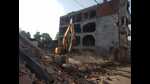 A bulldozer razing a commercial complex in the Akbar Nagar area of Lucknow on Sunday (HT photo) A bulldozer razing a commercial complex in the Akbar Nagar area of Lucknow on Sunday (HT photo)