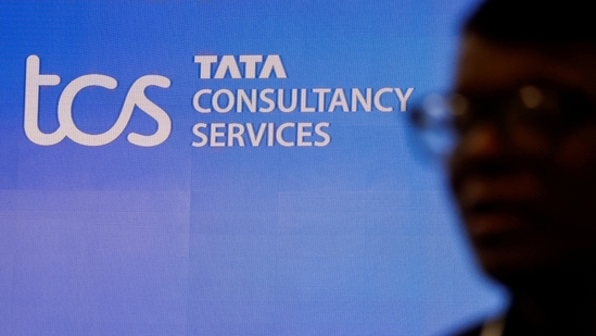 TCS hiring: A man walks past a logo of Tata Consultancy Services (TCS) before a press conference.(Reuters)