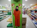 A hoarding with an image of Baba Ramdev is seen inside a Patanjali store. (REUTERS) A hoarding with an image of Baba Ramdev is seen inside a Patanjali store. (REUTERS)