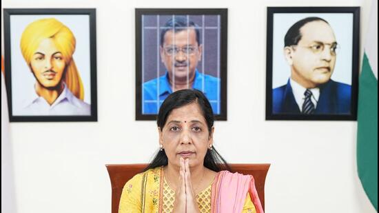 The photo forms the backdrop when Delhi CM Arvind Kejriwal's wife, Sunita Kejriwal issued a video statement on behalf of CM on Thursday. (HT Photo) The photo forms the backdrop when Delhi CM Arvind Kejriwal's wife, Sunita Kejriwal issued a video statement on behalf of CM on Thursday. (HT Photo)