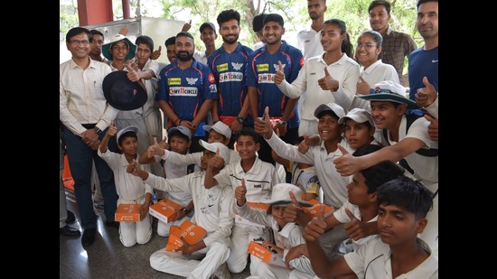Cricket trainees of the KD Singh Babu Stadium with LSG members, in Lucknow, on Friday. (HT Photo)