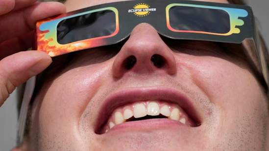 A man wears special glasses to watch the partial solar eclipse in Trafalgar Square, London, on June 10. The eclipse was expected to be partial, which means the people in its shadow weren't plunged into daytime darkness.(Frank Augstein / AP) A man wears special glasses to watch the partial solar eclipse in Trafalgar Square, London, on June 10. The eclipse was expected to be partial, which means the people in its shadow weren't plunged into daytime darkness.(Frank Augstein / AP)