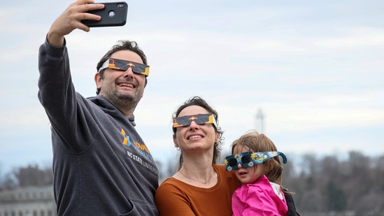 A family poses for a selfie during a total solar eclipse at Niagara Falls, New York, U.S.(REUTERS)