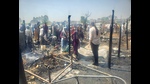 It took firefighters around two hours to bring the blaze under control. Officials said the illegal slum near Bhagomajra on Landran road in Mohali, housing migrant labourers, has around 250 shanties split into two sections. (HT Photo) It took firefighters around two hours to bring the blaze under control. Officials said the illegal slum near Bhagomajra on Landran road in Mohali, housing migrant labourers, has around 250 shanties split into two sections. (HT Photo)