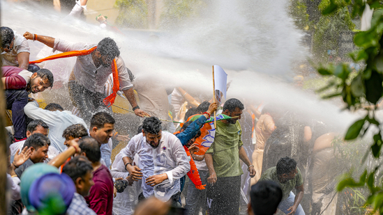 Security personnel use water cannon to disperse BJP workers protesting against AAP convener and Delhi CM Arvind Kejriwal, outside AAP office in New Delhi.(PTI)