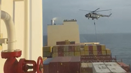 An official slides down a rope during a helicopter raid on MSC Aries ship.(via REUTERS)
