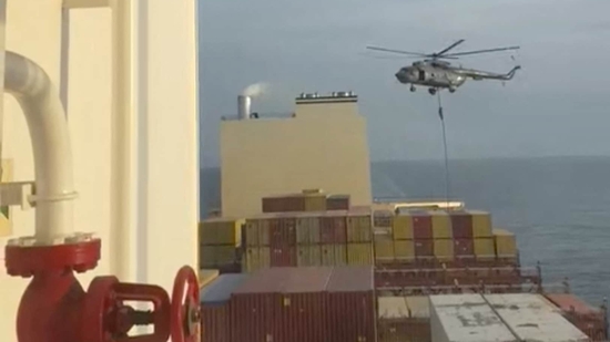 An official slides down a rope during a helicopter raid on MSC Aries ship.(via REUTERS)
