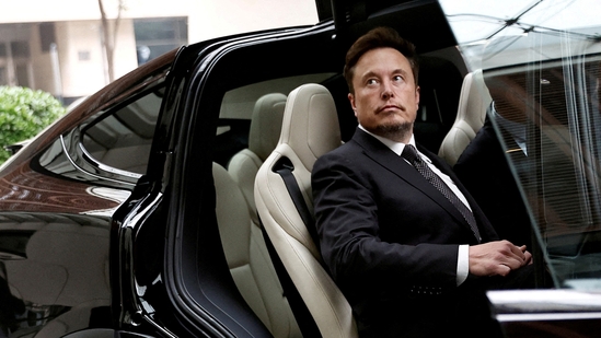 Tesla Chief Executive Officer Elon Musk gets in a Tesla car as he leaves a hotel in Beijing, China.(Reuters)