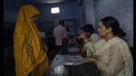 A polling official compares the photograph of a woman with her identity card before allowing her to cast her vote during the third round of voting in the six-week-long general election, in Agra on Tuesday. (AP Photo) A polling official compares the photograph of a woman with her identity card before allowing her to cast her vote during the third round of voting in the six-week-long general election, in Agra on Tuesday. (AP Photo)