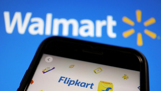 A mobile phone showing an image of Indian online retailer Flipkart is seen in front of a Walmart Inc logo displayed.(Reuters)