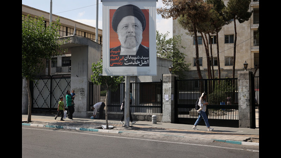 People walk near a banner with a picture of the late Iran's President Ebrahim Raisi on a street in Tehran, Iran on May 20 (via REUTERS/WANA) People walk near a banner with a picture of the late Iran's President Ebrahim Raisi on a street in Tehran, Iran on May 20 (via REUTERS/WANA)