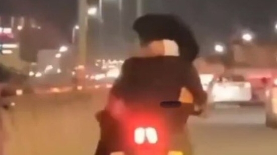 Man in Bengaluru booked for riding bike with a woman in his lap. VIDEO Man in Bengaluru booked for riding bike with a woman in his lap. VIDEO