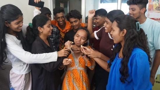 After the announcement of Maharashtra HSC Board 12th result, students are seen giving sweet in Thane(Praful Gangurde)