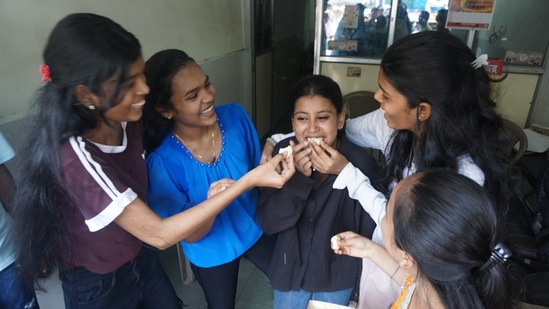 After the announcement of Maharashtra HSC Board 12th result, students are seen giving sweet in Thane(Praful Gangurde)