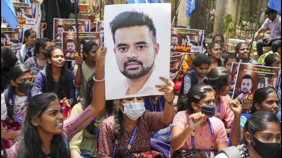 NSUI members hold a poster of JD(S) MP Prajwal Revanna during a protest against his involvement in the alleged sexual abuse case, in Bengaluru, on April 30, 2024. (PTI) NSUI members hold a poster of JD(S) MP Prajwal Revanna during a protest against his involvement in the alleged sexual abuse case, in Bengaluru, on April 30, 2024. (PTI)