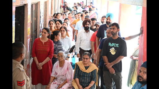 Voters wait in a queue at a polling booth in Mohali on Saturday. (Sanjeev Sharma/HT) Voters wait in a queue at a polling booth in Mohali on Saturday. (Sanjeev Sharma/HT)