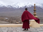 A Buddhist monk looks out to a snow-covered mountain range from Thiksay Monastery some 22 Km (13 miles) from Leh in the Indian Union territory of Ladakh on April 19, 2024. BUDDHISM (Photo by Mohd Arhaan ARCHER / AFP)(AFP) A Buddhist monk looks out to a snow-covered mountain range from Thiksay Monastery some 22 Km (13 miles) from Leh in the Indian Union territory of Ladakh on April 19, 2024. BUDDHISM (Photo by Mohd Arhaan ARCHER / AFP)(AFP)
