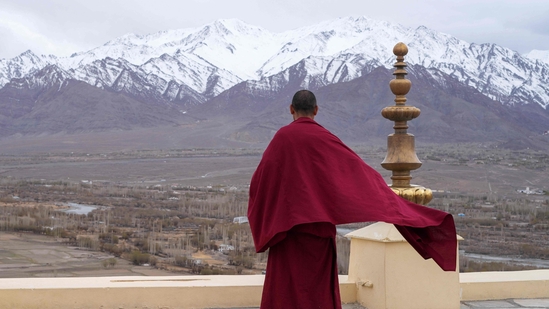 A Buddhist monk looks out to a snow-covered mountain range from Thiksay Monastery some 22 Km (13 miles) from Leh in the Indian Union territory of Ladakh on April 19, 2024. BUDDHISM (Photo by Mohd Arhaan ARCHER / AFP)(AFP) A Buddhist monk looks out to a snow-covered mountain range from Thiksay Monastery some 22 Km (13 miles) from Leh in the Indian Union territory of Ladakh on April 19, 2024. BUDDHISM (Photo by Mohd Arhaan ARCHER / AFP)(AFP)