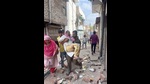 Mohammed Ahmed, a resident, helps his ailing mother move amid a demolition exercise in Akbar Nagar (HT) Mohammed Ahmed, a resident, helps his ailing mother move amid a demolition exercise in Akbar Nagar (HT)