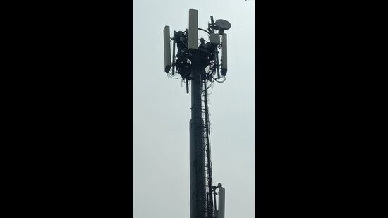 Upset over salary cut, bus driver climbs mobile tower in protest (HT photo) Upset over salary cut, bus driver climbs mobile tower in protest (HT photo)