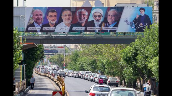 Vehicles move past a billboard displaying the faces of the six presidential candidates (L-R) Mohammad Bagher Ghalibaf, Amirhossein Ghazizadeh-Hashemi Alireza Zakani, Saeed Jalili, Mostafa Pourmohammadi and Masoud Pezeshkianin in the Iranian capital Tehran on June 29, 2024. Iran's sole reformist candidate Masoud Pezeshkian and ultraconservative Saeed Jalili are set to go to runoffs after securing the highest number of votes in Iran's presidential election, the interior ministry said. (Photo by ATTA KENARE / AFP) (AFP) Vehicles move past a billboard displaying the faces of the six presidential candidates (L-R) Mohammad Bagher Ghalibaf, Amirhossein Ghazizadeh-Hashemi Alireza Zakani, Saeed Jalili, Mostafa Pourmohammadi and Masoud Pezeshkianin in the Iranian capital Tehran on June 29, 2024. Iran's sole reformist candidate Masoud Pezeshkian and ultraconservative Saeed Jalili are set to go to runoffs after securing the highest number of votes in Iran's presidential election, the interior ministry said. (Photo by ATTA KENARE / AFP) (AFP)
