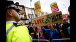 Residents hold placards during a counter demonstration against an anti-immigration protest called by far-right activists in the Walthamstow suburb of London on August 7, 2024. (Photo by BENJAMIN CREMEL / AFP) (AFP) Residents hold placards during a counter demonstration against an anti-immigration protest called by far-right activists in the Walthamstow suburb of London on August 7, 2024. (Photo by BENJAMIN CREMEL / AFP) (AFP)