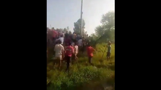 A grab from a video showing a mob chasing three cattle thieves in a village near Bareilly’s Aonla town. The trio were finally rescued and taken into custody when a deputy superintendent of police-rank officer and the Aonla circle officer (CO) reached the spot with personnel from three police stations. (Sourced) A grab from a video showing a mob chasing three cattle thieves in a village near Bareilly’s Aonla town. The trio were finally rescued and taken into custody when a deputy superintendent of police-rank officer and the Aonla circle officer (CO) reached the spot with personnel from three police stations. (Sourced)