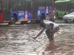 New Delhi, India - July 9, 2024: NDMC worker trying to open the choked drains on a water-logged street after heavy rains at Rafi Marg in New Delhi, India, on Tuesday, July 9, 2024. Heavy rains caused major waterlogging in many areas, leaving residents and commuters stranded, and causing a huge traffic gridlock. Waterlogging in many areas has led to divert bus routes. (Photo by Raj K Raj/ Hindustan Times)(Hindustan Times) New Delhi, India - July 9, 2024: NDMC worker trying to open the choked drains on a water-logged street after heavy rains at Rafi Marg in New Delhi, India, on Tuesday, July 9, 2024. Heavy rains caused major waterlogging in many areas, leaving residents and commuters stranded, and causing a huge traffic gridlock. Waterlogging in many areas has led to divert bus routes. (Photo by Raj K Raj/ Hindustan Times)(Hindustan Times)