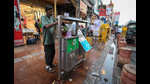 Workers on Tuesday were seen clearing the overflowing garbage bins, but other sanitation work handled by the private contractor would be taken over soon, MCD said. (Sanchit Khanna/HT Photo) Workers on Tuesday were seen clearing the overflowing garbage bins, but other sanitation work handled by the private contractor would be taken over soon, MCD said. (Sanchit Khanna/HT Photo)