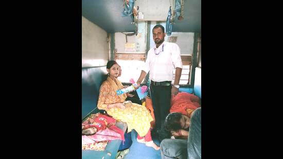 Commercial Control of Varanasi Division, Deepak Kumar Malla, with the woman and her infant (HT)