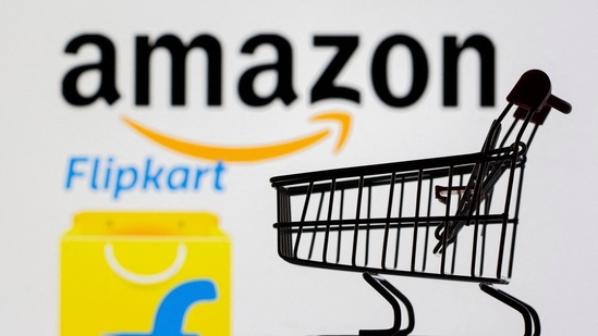 Small toy shopping cart is seen in front of displayed Amazon and Flipkart logos in this picture illustration taken, July 30, 2021 ((Dado Ruvic/Reuters))