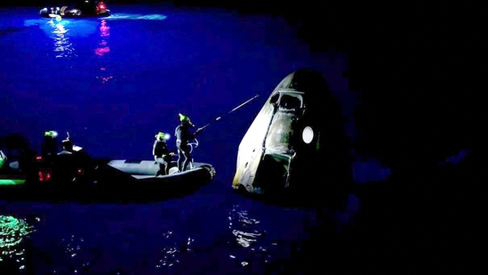 TOPSHOT - This still image taken from a SpaceX and Polaris broadcast on September 15, 2024, shows staff members approching the manned Polaris Dawn mission's "Dragon" capsule after it splashed down off the coast of Dry Tortugas, Florida, completing the first human spaceflight mission by non-government astronauts of the Polaris Program. The SpaceX Polaris Dawn mission, which made history when its crew conducted the first spacewalk by non-government astronauts, splashed down off the coast of Florida early on September 15, 2024. The Dragon spacecraft landed in the ocean at 3:37 am (0737 GMT), a webcast of the splashdown showed, with a recovery team deploying in the pre-dawn darkness to retrieve the capsule and crew. The capsule was lifted from the water and onto the recovery vessel half a hour later. (Photo by Polaris Program / AFP) / XGTY / RESTRICTED TO EDITORIAL USE - MANDATORY CREDIT "AFP PHOTO / SpaceX / Polaris" - NO MARKETING NO ADVERTISING CAMPAIGNS - DISTRIBUTED AS A SERVICE TO CLIENTS(AFP) TOPSHOT - This still image taken from a SpaceX and Polaris broadcast on September 15, 2024, shows staff members approching the manned Polaris Dawn mission's "Dragon" capsule after it splashed down off the coast of Dry Tortugas, Florida, completing the first human spaceflight mission by non-government astronauts of the Polaris Program. The SpaceX Polaris Dawn mission, which made history when its crew conducted the first spacewalk by non-government astronauts, splashed down off the coast of Florida early on September 15, 2024. The Dragon spacecraft landed in the ocean at 3:37 am (0737 GMT), a webcast of the splashdown showed, with a recovery team deploying in the pre-dawn darkness to retrieve the capsule and crew. The capsule was lifted from the water and onto the recovery vessel half a hour later. (Photo by Polaris Program / AFP) / XGTY / RESTRICTED TO EDITORIAL USE - MANDATORY CREDIT "AFP PHOTO / SpaceX / Polaris" - NO MARKETING NO ADVERTISING CAMPAIGNS - DISTRIBUTED AS A SERVICE TO CLIENTS(AFP)