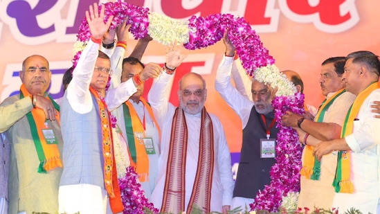 Union home minister Amit Shah acknowledges supporters at an election rally in Haryana's Loharu. Union home minister Amit Shah acknowledges supporters at an election rally in Haryana's Loharu.