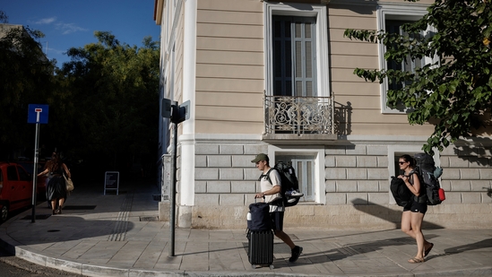 Tourists carry their luggage in the neighborhood of Koukaki, in Athens, Greece. Travelling to Athens? Here's how new rental rules in Greece could affect your vacation (REUTERS/Louiza Vradi)