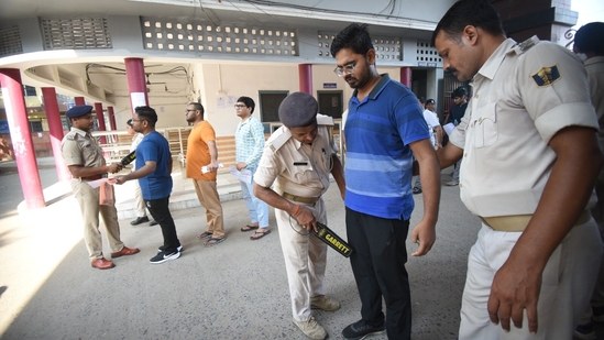Applicants are inspected by a police person before entering the exam centre to appear for the Civil Services (Main) Examination in Patna. (Santosh Kumar )