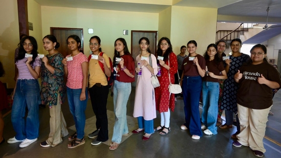 Students along with their identity cards pose for photographs as they wait to cast their vote during the Delhi University Students Union (DUSU) Election at Miranda House in North Campus. (Raj k Raj)