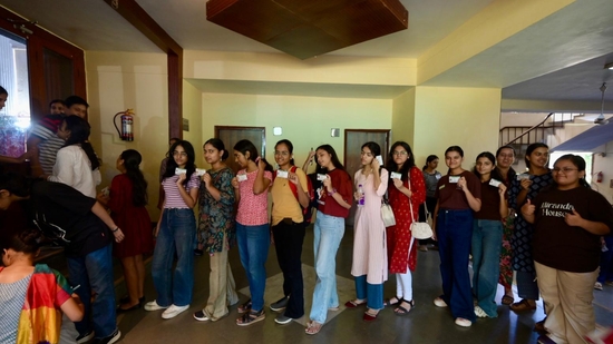 Delhi University students with their ID card waiting outside the voting centre for DUSU polls. (Raj k Raj)