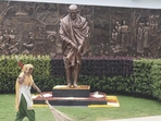 A worker sweeps an area near a statue of Mahatma Gandhi inside the Rashtriya Swachhata Kendra. (PTI) A worker sweeps an area near a statue of Mahatma Gandhi inside the Rashtriya Swachhata Kendra. (PTI)