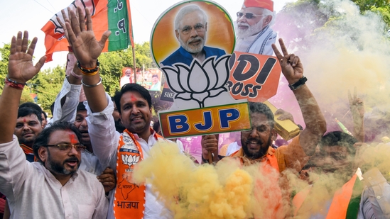Bharatiya Janata Party (BJP) supporters celebrate the party's lead during the counting of votes for the Haryana Assembly elections, at BJP headquarters in New Delhi on Tuesday.(ANI/Amit Sharma )