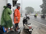 Two men who were riding a two-wheeler take shelter outside a closed shop during a heavy rain in Kochi, southern Kerala state, India. (AP Photo/ R S Iyer) Two men who were riding a two-wheeler take shelter outside a closed shop during a heavy rain in Kochi, southern Kerala state, India. (AP Photo/ R S Iyer)