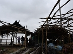 Villagers stand near damaged temporary houses following the landfall of cyclone Dana in East Midnapore district around 180km southwest of Kolkata, on October 25, 2024. Cyclone Dana uprooted trees and power lines after making landfall on India's east coast, with officials warning of more fierce weather on October 25. (Photo by DIBYANGSHU SARKAR / AFP)(AFP) Villagers stand near damaged temporary houses following the landfall of cyclone Dana in East Midnapore district around 180km southwest of Kolkata, on October 25, 2024. Cyclone Dana uprooted trees and power lines after making landfall on India's east coast, with officials warning of more fierce weather on October 25. (Photo by DIBYANGSHU SARKAR / AFP)(AFP)