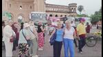 Tourists taking photographs in front of Rumi Gate on Thursday with buses in the background. (Sourced) Tourists taking photographs in front of Rumi Gate on Thursday with buses in the background. (Sourced)