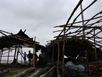 Villagers stand near damaged temporary houses following the landfall of cyclone Dana in East Midnapore district around 180km southwest of Kolkata, on October 25, 2024. Cyclone Dana uprooted trees and power lines after making landfall on India's east coast, with officials warning of more fierce weather on October 25. (Photo by DIBYANGSHU SARKAR / AFP)(AFP) Villagers stand near damaged temporary houses following the landfall of cyclone Dana in East Midnapore district around 180km southwest of Kolkata, on October 25, 2024. Cyclone Dana uprooted trees and power lines after making landfall on India's east coast, with officials warning of more fierce weather on October 25. (Photo by DIBYANGSHU SARKAR / AFP)(AFP)