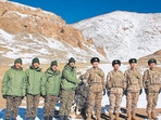 Indian and Chinese army soldiers exchange sweets along the Line of Actual Control (LAC) near Karakoram pass in Ladakh on Thursday. (AFP) Indian and Chinese army soldiers exchange sweets along the Line of Actual Control (LAC) near Karakoram pass in Ladakh on Thursday. (AFP)