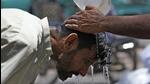A person pours water on another man to cool off during a hot day in Karachi, Pakistan in May this year. (AP Photo) A person pours water on another man to cool off during a hot day in Karachi, Pakistan in May this year. (AP Photo)