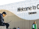 A man uses his laptop as he sits near the COP29 United Nations climate change conference pavilion, in Baku, Azerbaijan, on Friday. (REUTERS) A man uses his laptop as he sits near the COP29 United Nations climate change conference pavilion, in Baku, Azerbaijan, on Friday. (REUTERS)