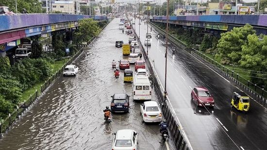 Vehicles ply on a waterlogged road following heavy rainfall triggered by Cyclone Fengal, in Chennai.(ANI)