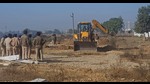 Officials in an unauthorised colony during the demolition drive in Ludhiana on Wednesday. (HT photo) Officials in an unauthorised colony during the demolition drive in Ludhiana on Wednesday. (HT photo)