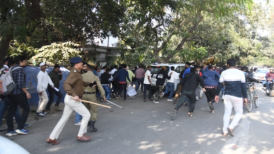 Police running behind students who were protesting against 70th CCE prelims normalization rule outside BPSC office in Patna. (Santosh Kumar )